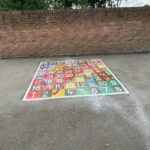 Snakes and ladders marking by wall